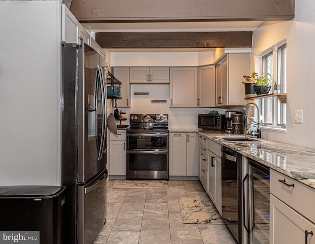 kitchen featuring gray cabinetry, light stone countertops, sink, stainless steel appliances, and wine cooler