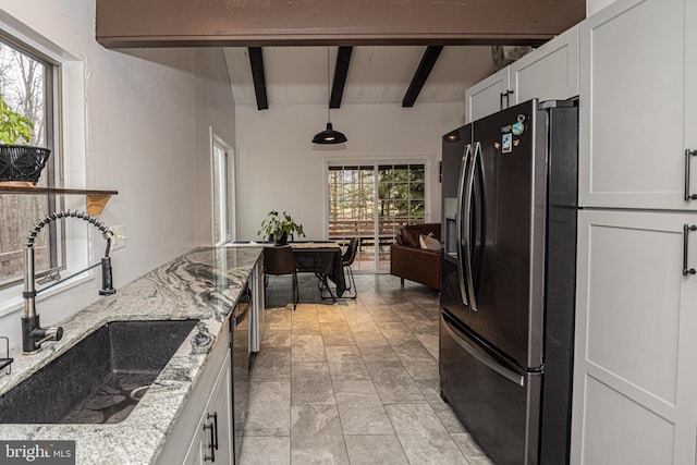 kitchen with white cabinets, appliances with stainless steel finishes, a healthy amount of sunlight, and sink