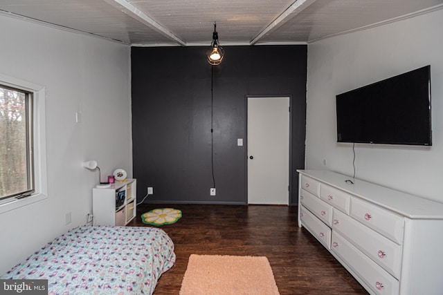 bedroom with multiple windows, beamed ceiling, and dark wood-type flooring