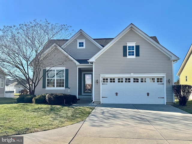 view of front of house featuring a garage and a front lawn