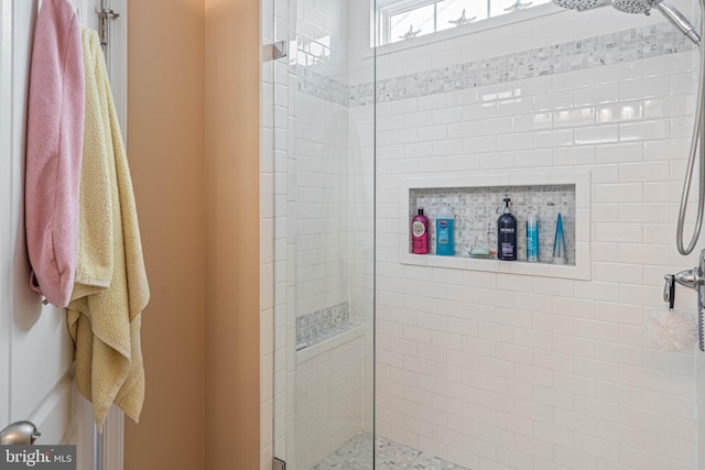 bathroom with a shower with shower door