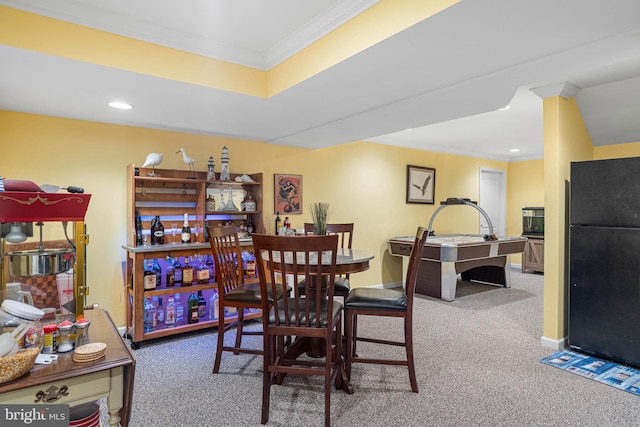 carpeted dining space with ornamental molding