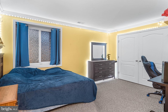 carpeted bedroom featuring crown molding and a closet