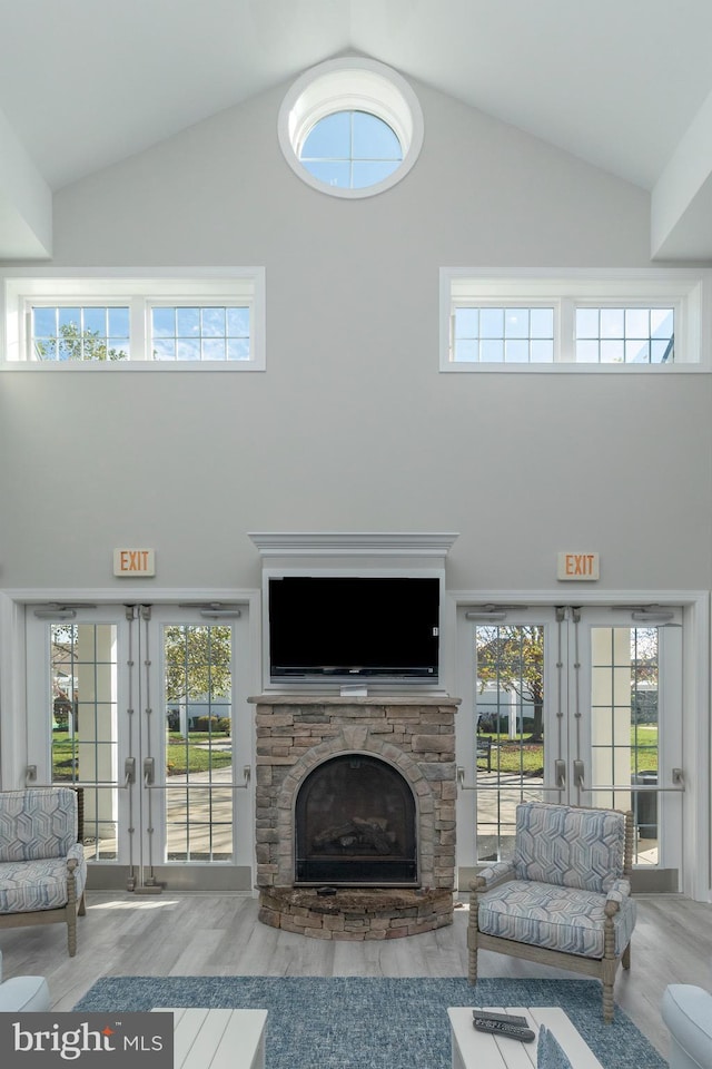 living room featuring french doors and high vaulted ceiling