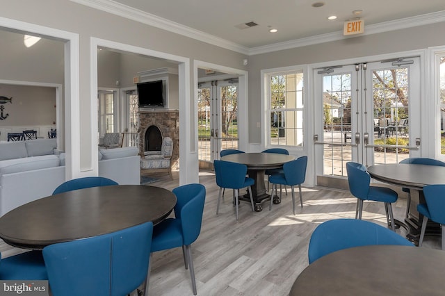 sunroom / solarium with a fireplace and french doors