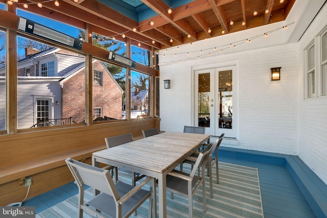 sunroom / solarium featuring french doors and beam ceiling