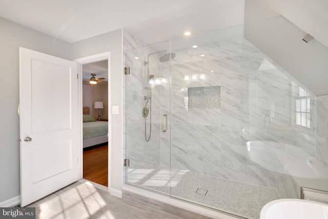 bathroom with ceiling fan and an enclosed shower