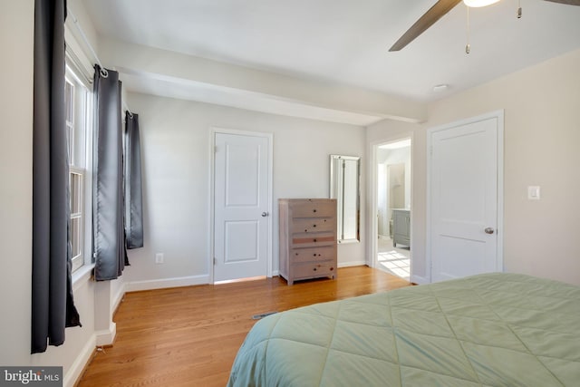 bedroom with ceiling fan, ensuite bathroom, and light hardwood / wood-style flooring