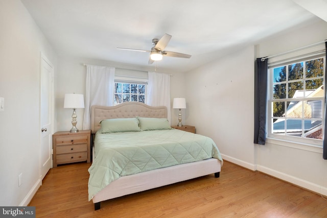 bedroom with ceiling fan and light hardwood / wood-style floors