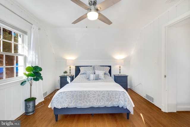 bedroom featuring hardwood / wood-style flooring, ceiling fan, and vaulted ceiling