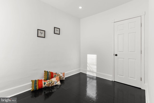 empty room with dark wood-type flooring