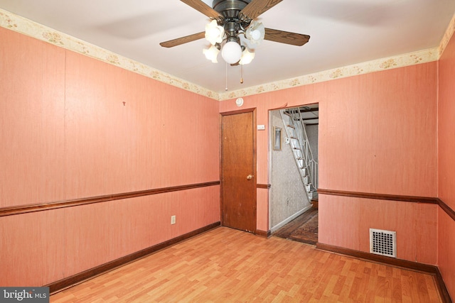 unfurnished room with ceiling fan and light wood-type flooring