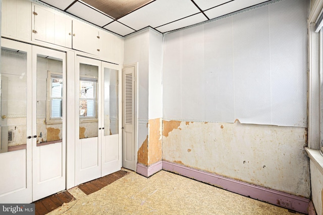 interior space featuring french doors and a paneled ceiling