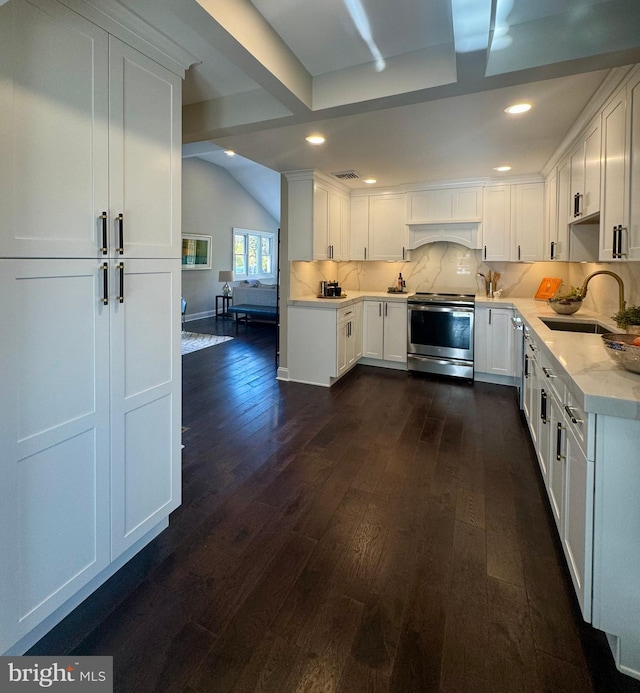 kitchen with dark wood-type flooring, white cabinets, sink, decorative backsplash, and appliances with stainless steel finishes