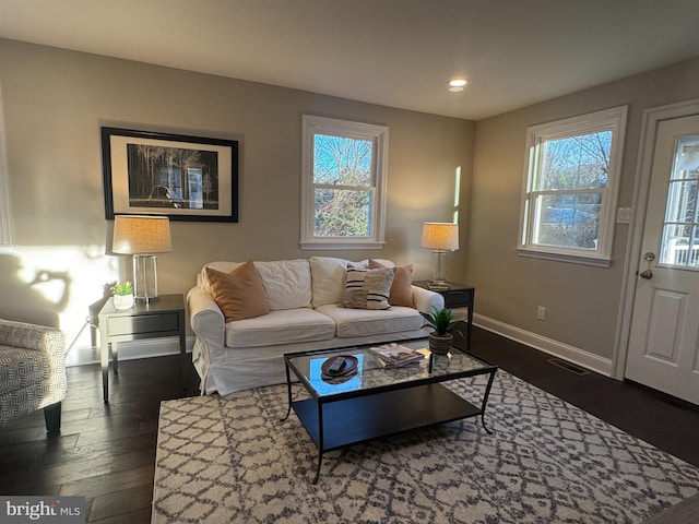 living room with dark hardwood / wood-style flooring