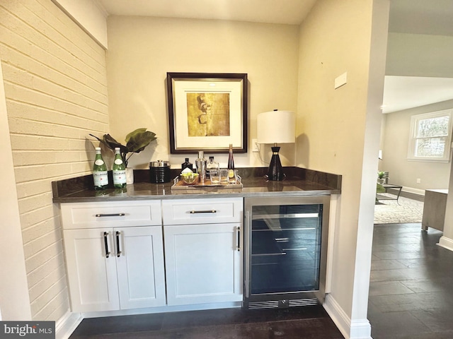 bar with white cabinetry and beverage cooler