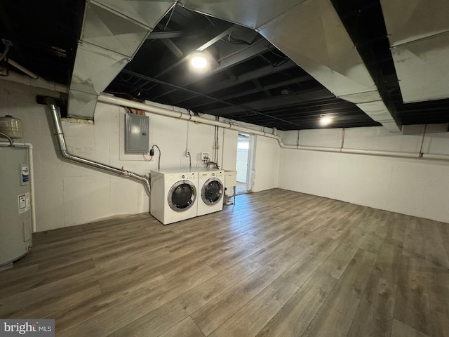 laundry room featuring independent washer and dryer, electric water heater, electric panel, and wood-type flooring