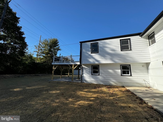 back of house featuring a patio and a wooden deck