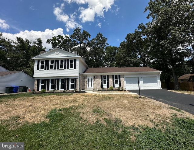 view of front of house with a front yard and a garage