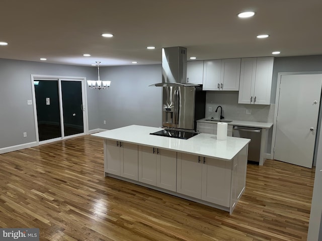 kitchen with dark hardwood / wood-style floors, a kitchen island, island exhaust hood, and stainless steel appliances