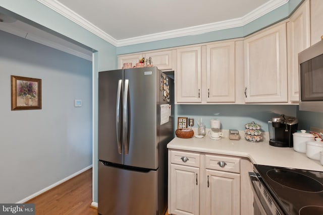 kitchen featuring ornamental molding, appliances with stainless steel finishes, and light wood-type flooring