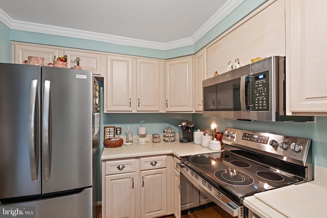 kitchen with ornamental molding and appliances with stainless steel finishes