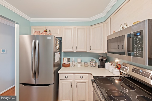 kitchen featuring ornamental molding, stainless steel appliances, and light hardwood / wood-style floors