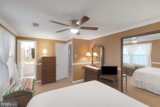 bedroom featuring ceiling fan, light colored carpet, ornamental molding, and ensuite bathroom