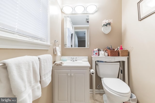 bathroom featuring vanity, tile patterned floors, and toilet