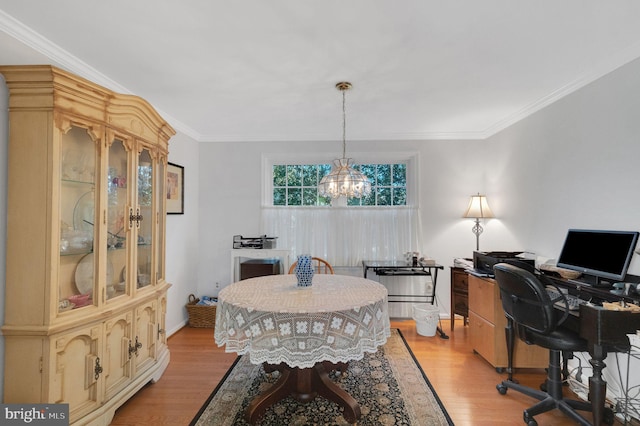 home office with crown molding, a chandelier, and light hardwood / wood-style flooring