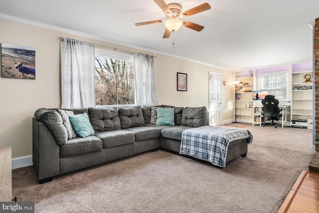 living room with hardwood / wood-style flooring, ceiling fan, and crown molding