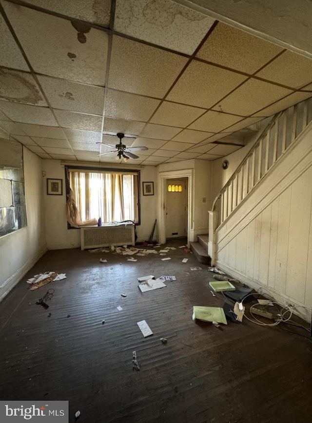 miscellaneous room featuring a drop ceiling, dark wood-type flooring, and ceiling fan