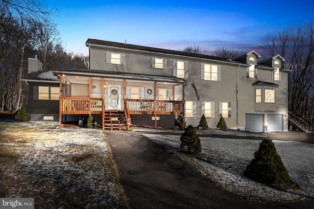 view of front of home featuring a porch and a garage