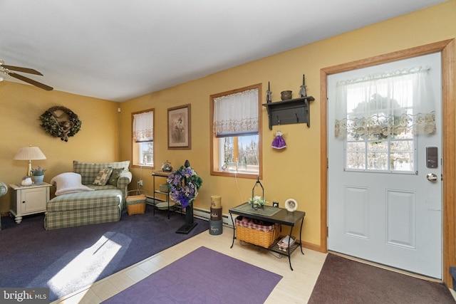 carpeted foyer entrance with ceiling fan