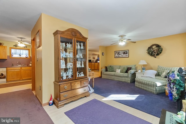 living room featuring ceiling fan and sink