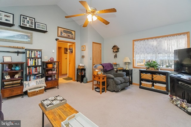 carpeted living room with ceiling fan and lofted ceiling