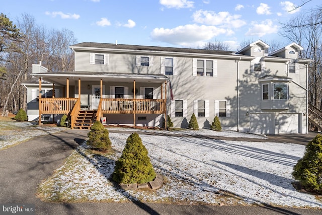 view of front of home featuring covered porch and a garage