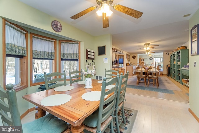 dining space featuring ceiling fan and light hardwood / wood-style flooring