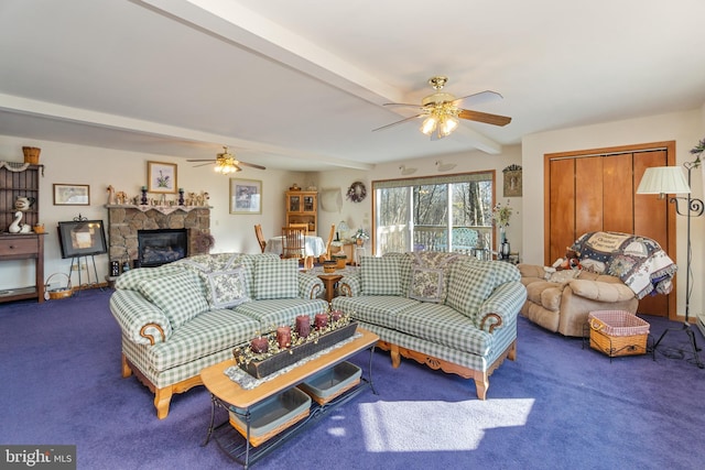 carpeted living room with ceiling fan, a fireplace, and beamed ceiling