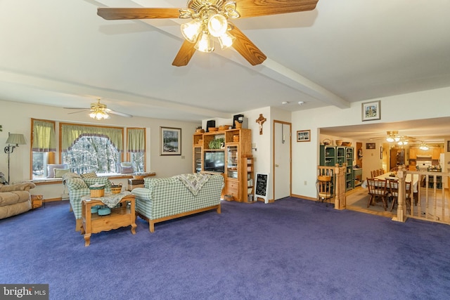 living room featuring beamed ceiling and carpet floors