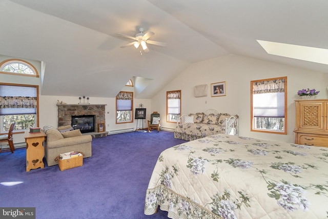 bedroom featuring vaulted ceiling with skylight, carpet flooring, ceiling fan, and multiple windows