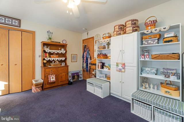 misc room featuring dark carpet and ceiling fan