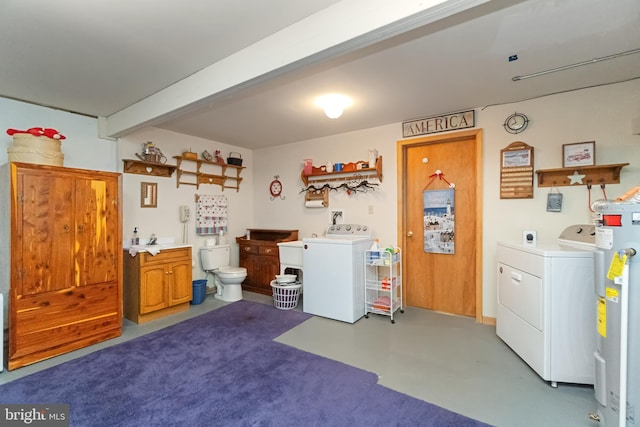 washroom with electric water heater and washer / clothes dryer