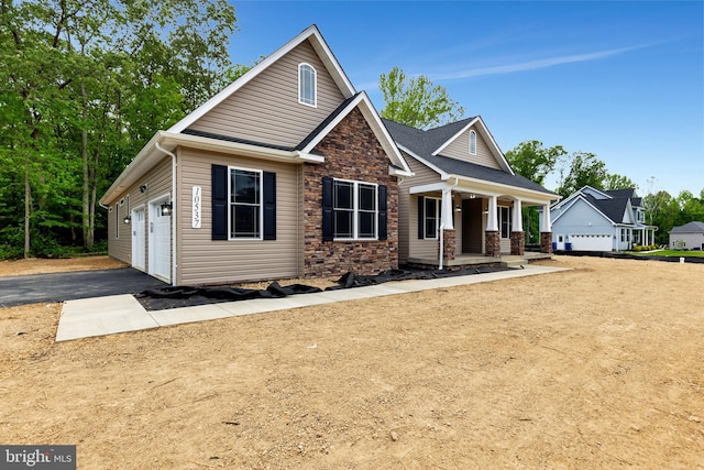 view of front of house featuring covered porch and a garage