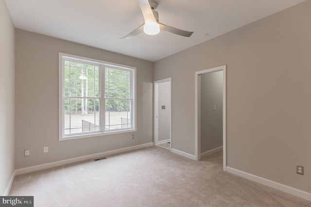 carpeted empty room with ceiling fan