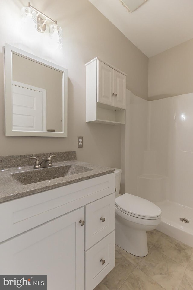 bathroom featuring walk in shower, tile patterned floors, vanity, and toilet