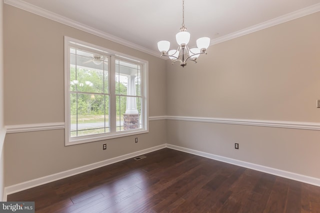 spare room with dark hardwood / wood-style flooring, a wealth of natural light, and a notable chandelier