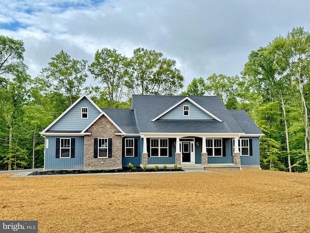 4035 Tamaron Ct, Brandywine, MD 20613 - craftsman-style home featuring covered porch, board and batten siding, stone siding, roof with shingles, and a front yard