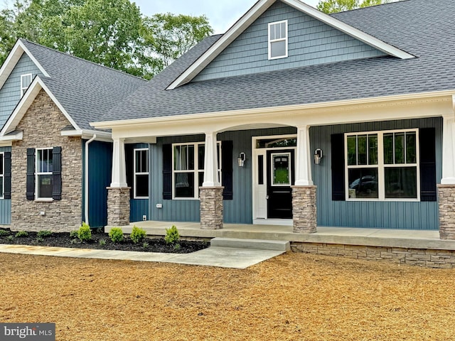 4035 Tamaron Ct, Brandywine, MD 20613 - craftsman-style home featuring a shingled roof, stone siding, covered porch, and board and batten siding