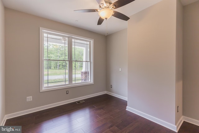 spare room with dark hardwood / wood-style floors and ceiling fan